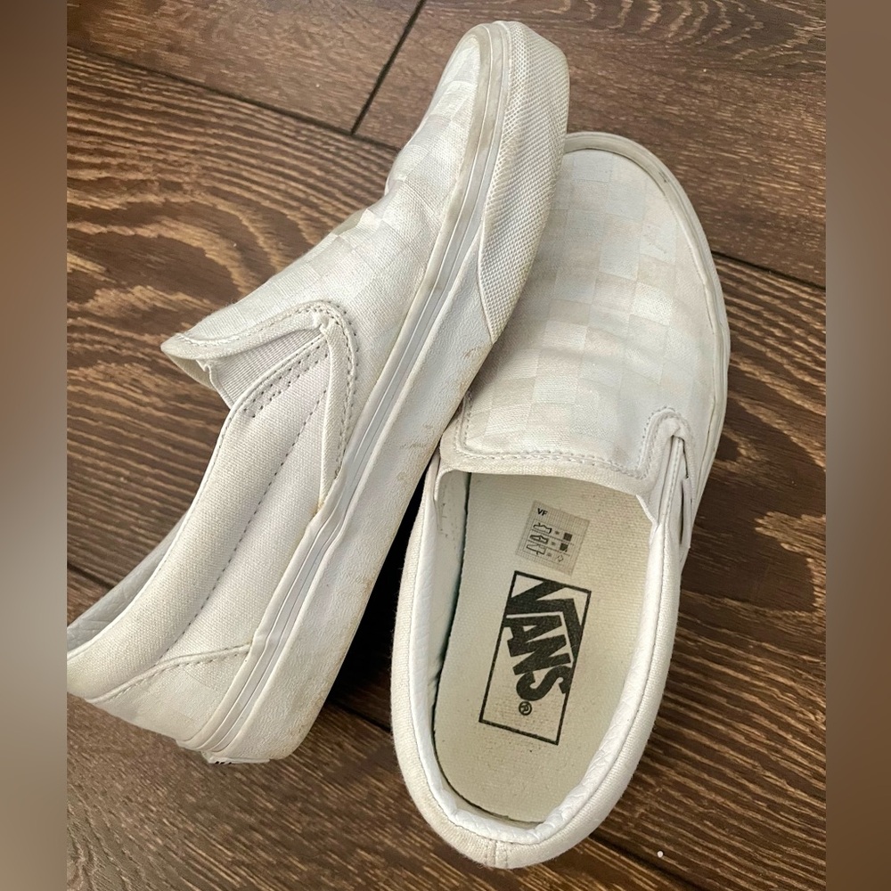 Woman’s white checkered Vans